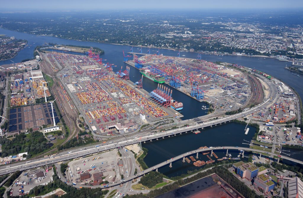 Aerial view of container ships and rows of stacked shipping containers at the Eurogate and Burchardkai container terminals in the Port of Hamburg