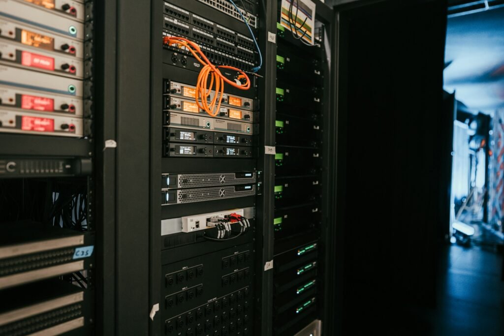 Rows of illuminated server racks in a data center, representing distributed and edge computing infrastructure