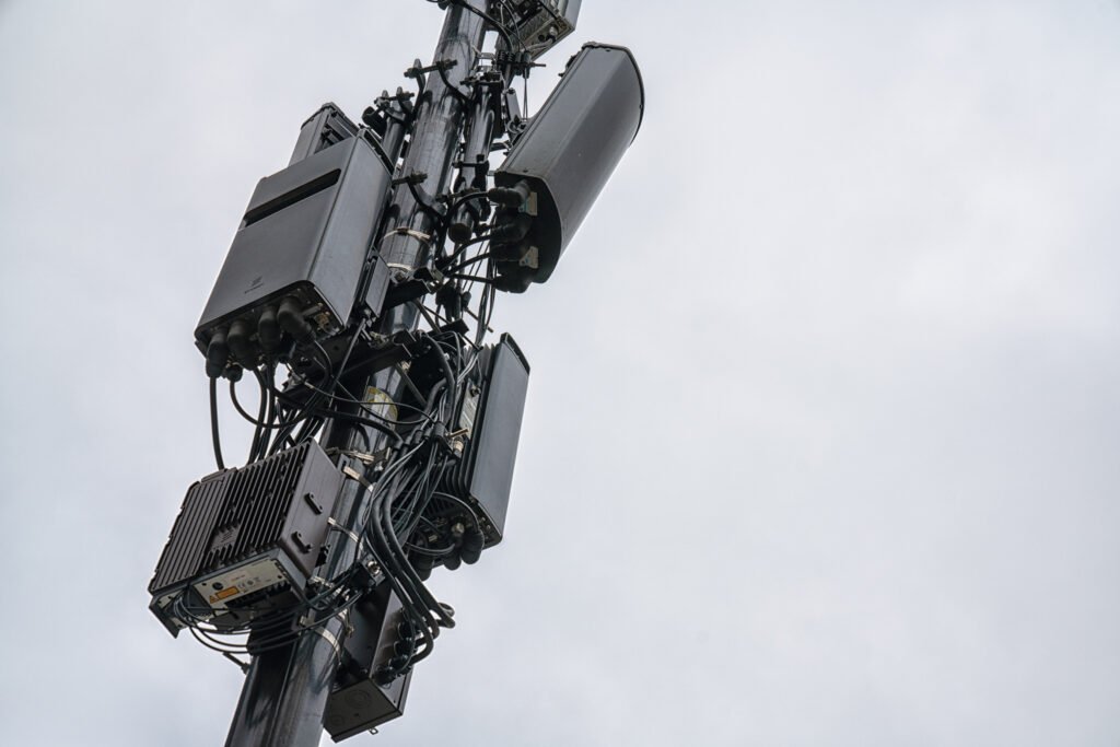 5G cellular antenna equipment mounted on a cell tower, showing the added hardware that distinguishes 5G from 4G networks.