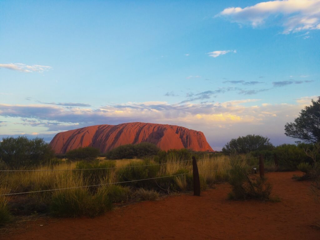 Uluru glowing red at sunset in the Australian Outback