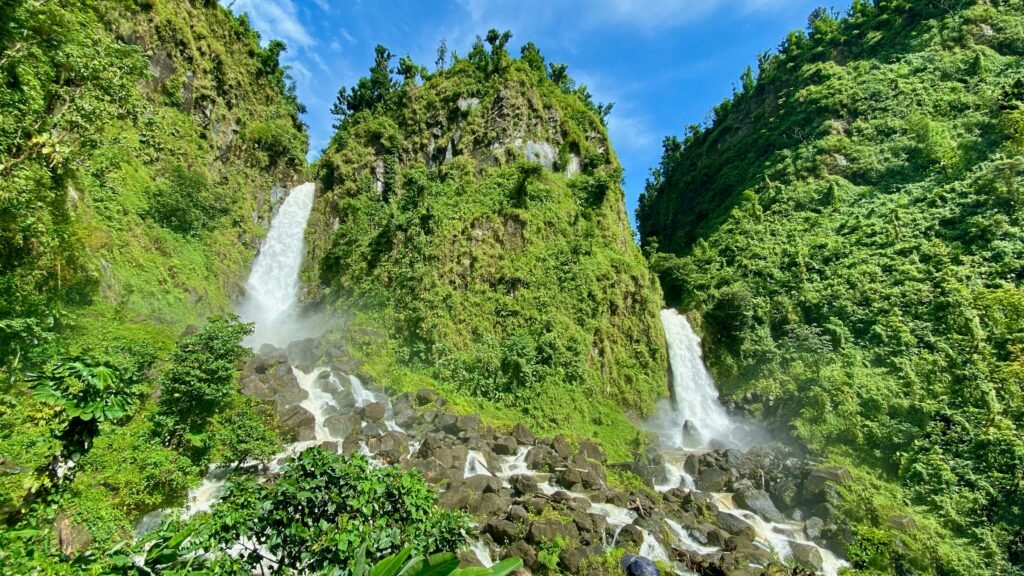 A waterfall in Dominica's rainforest, illustrating the volcanic island terrain known as the Nature Island of the Caribbean