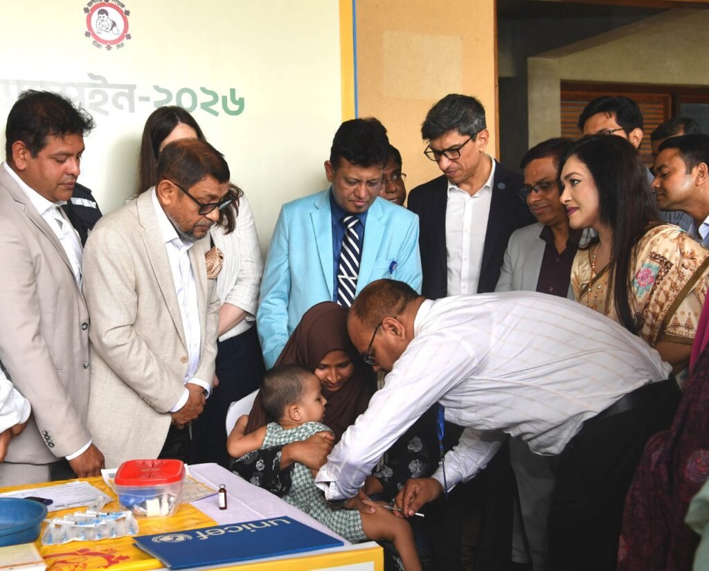 A health worker giving a child a measles and rubella vaccination during a campaign in Rupganj, Bangladesh.