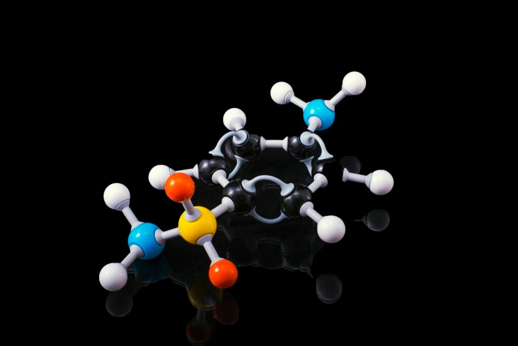 A ball and stick molecular model with colored spheres joined by rods