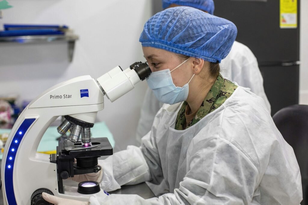 A scientist looking through a microscope in a research laboratory