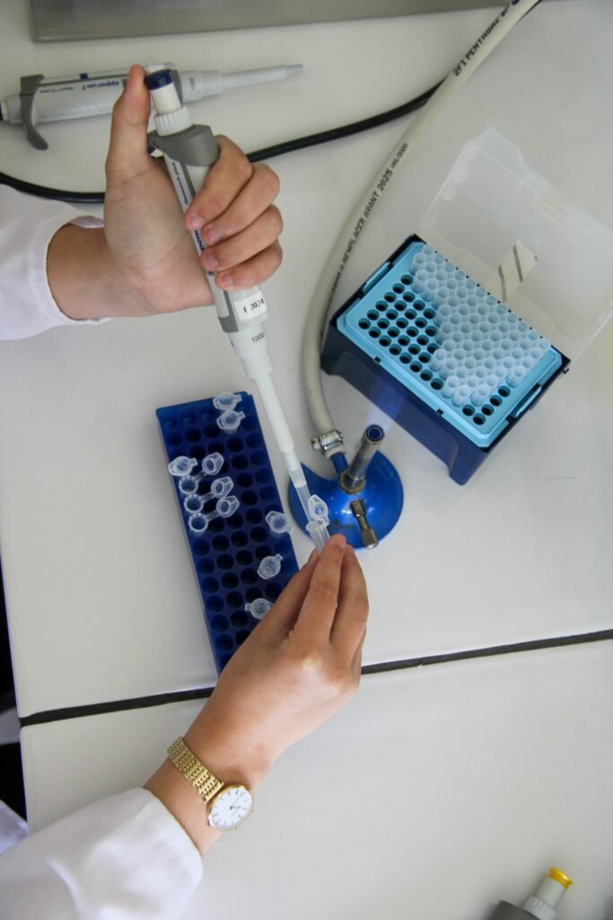 A scientist using a pipette in a research laboratory