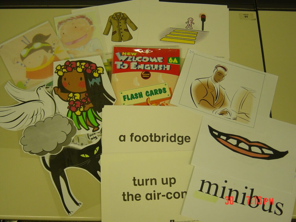 A set of handwritten vocabulary flashcards laid out on a surface.