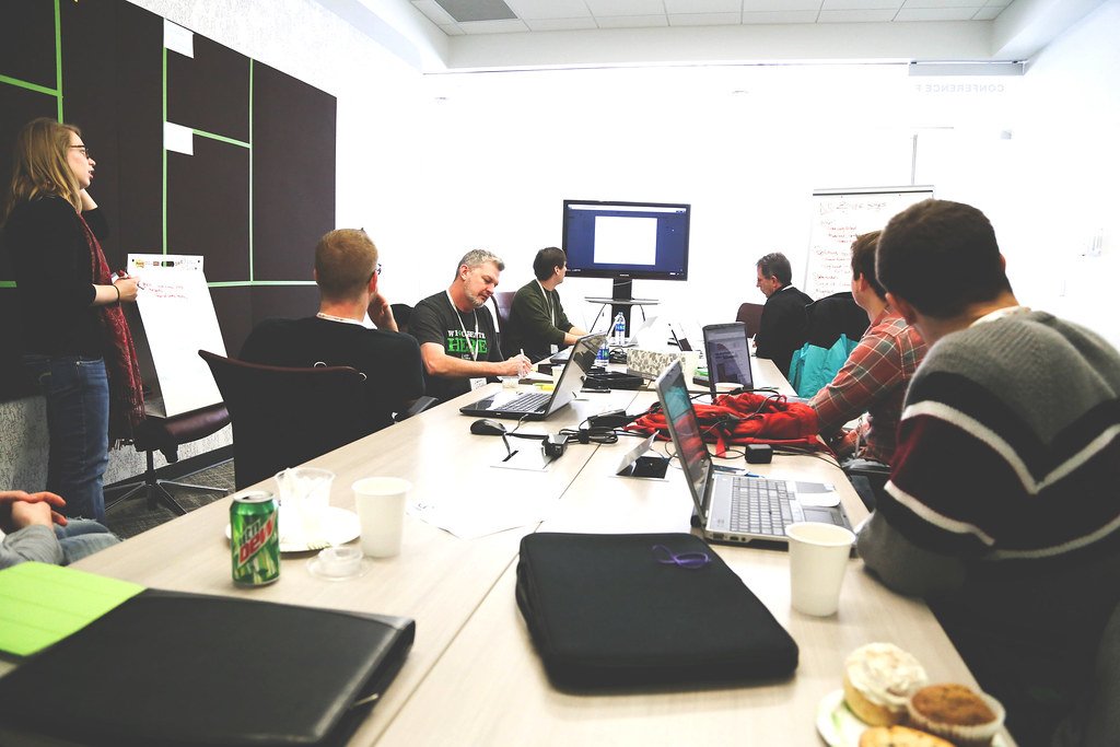 Startup founders in a team meeting discussing venture capital and angel investment funding options