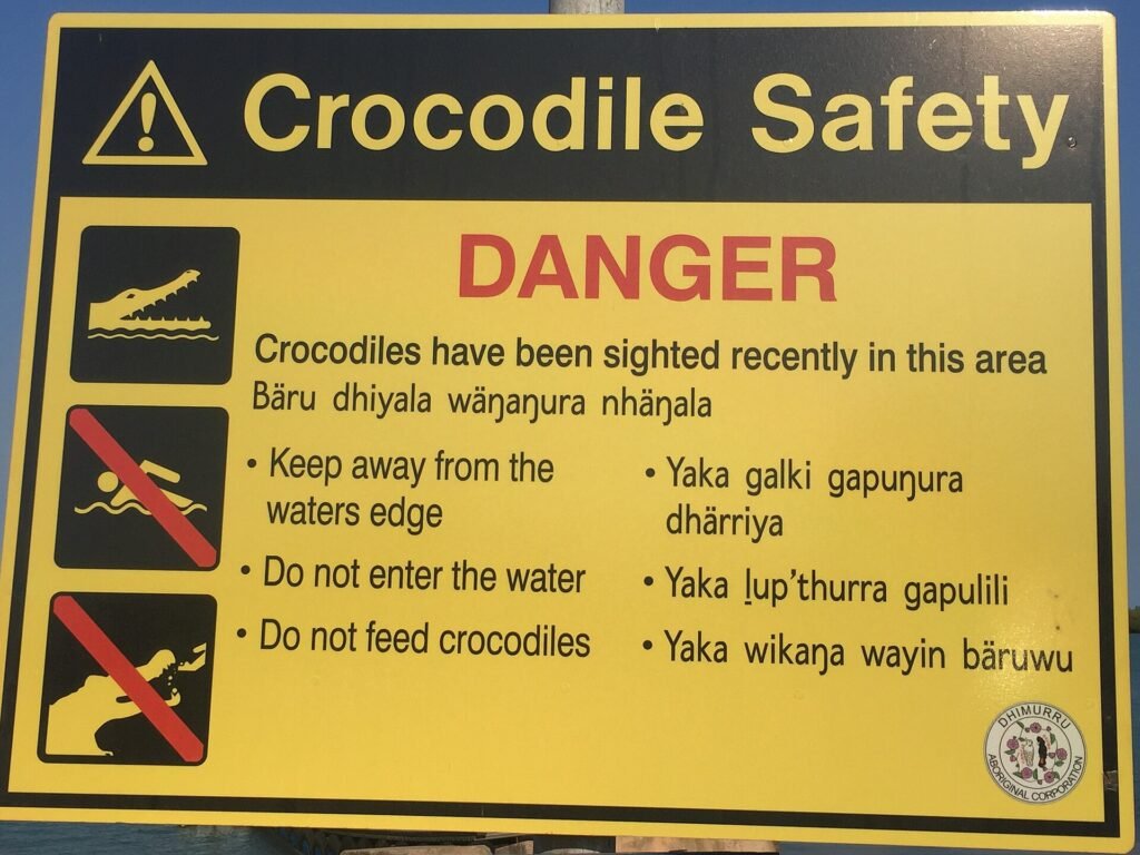 A crocodile warning sign in northern Australia written in both English and Yolngu