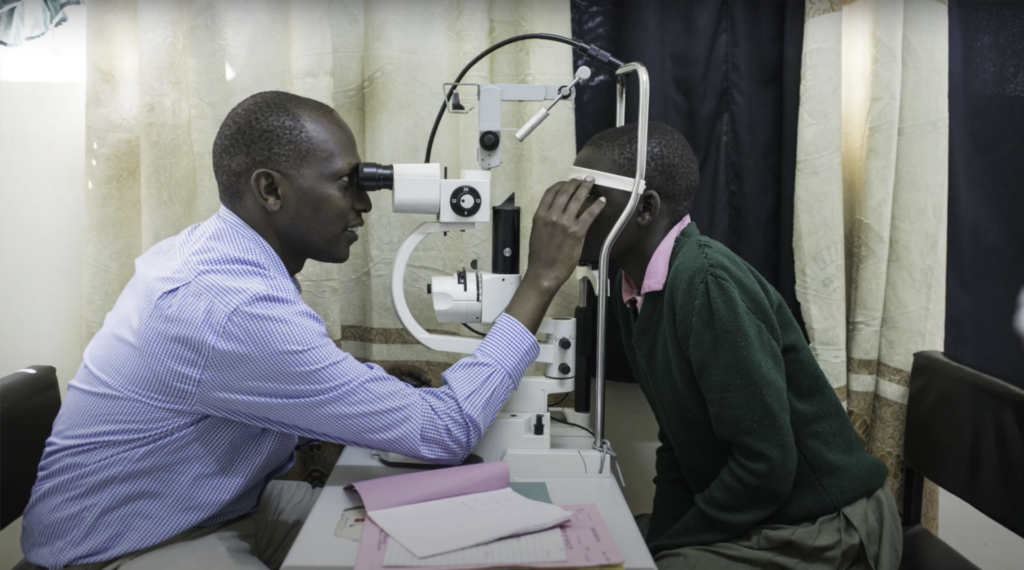 A doctor examining a patient at an eye clinic in Kitale, Kenya